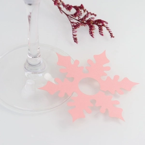 Close-up of pink snowflake place card for wine glasses with pearlescent finish