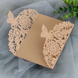 Detailed laser-cut wedding invitation cover with intricate floral and butterfly patterns