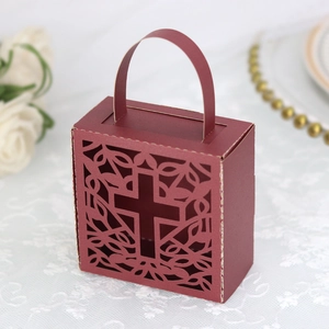 Detail of burgundy cross cutout gift box with elegant handle for wedding candy favors