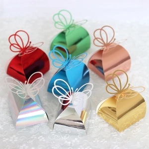 Macro detail of hollow butterfly laser-cut gift boxes in various metallic colors