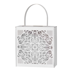 Macro detail of white laser-cut lace pattern on elegant wedding favor gift box