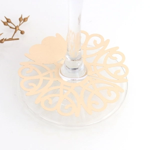 Champagne gold laser-cut wine glass place card with heart design on white background
