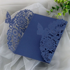 Detailed laser-cut navy blue wedding invitation cover with butterfly and floral hollow patterns