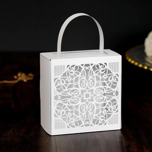 Detailed laser-cut mandala lace pattern on elegant white wedding favor gift box