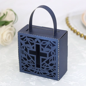 Detailed laser-cut cross and floral pattern on a navy blue paper wedding favor box