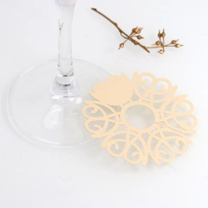 Detail of laser-cut champagne gold wine glass card with elegant heart and vine patterns