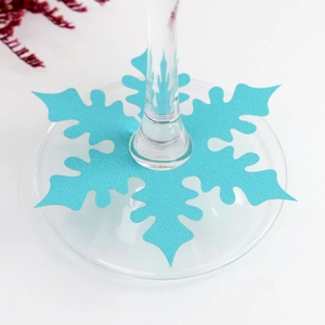 Macro detail of a light blue snowflake place card for wine glass base with paper texture
