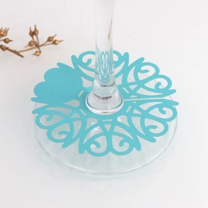 Macro view of light blue heart-shaped laser-cut place card on a wine glass base