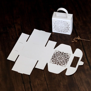 Detailed laser-cut lace wedding favor box with handle and DIY flat unfolded sheet