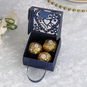 Detailweergave van de donkerblauwe geschenkdoos met hartlaser-snede en chocolaatjes