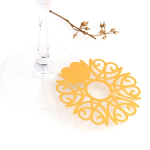 Detailed laser-cut gold cup card with hollow heart and swirl patterns for wedding stemware
