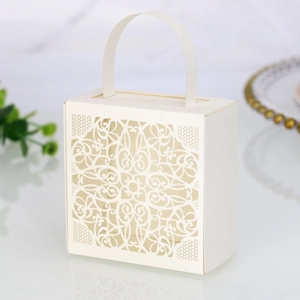 Macro shot of off-white laser-cut lace pattern on a stylish wedding favor gift box