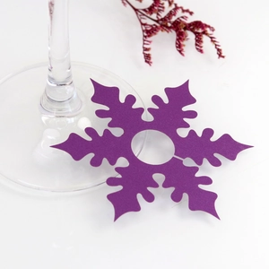 Macro detail of purple snowflake wine glass name card for festive table decoration