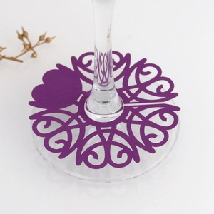 Detail of purple laser-cut wine glass place card with intricate filigree patterns
