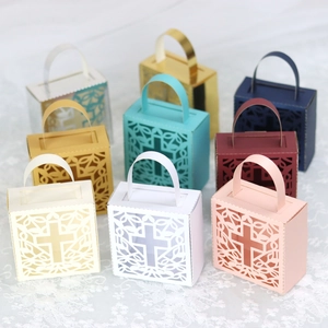 Detail of laser-cut cross pattern candy gift boxes in various elegant colors