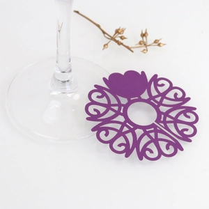 Purple laser-cut paper wine glass place card with heart-shaped scrollwork for weddings