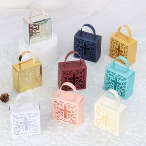 Detail of laser-cut cross patterns on elegant wedding favor boxes in various colors