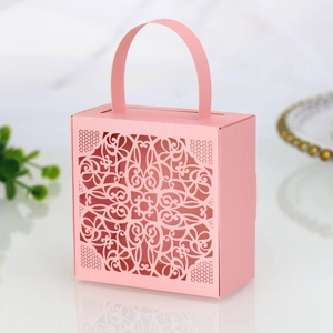 Close-up of pink laser-cut lace pattern on pearlescent cardstock wedding candy box