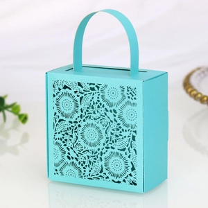 Detail of laser-cut floral pattern on Tiffany blue paper gift box with handle