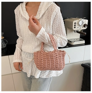 Close-up of pink woven bucket bag with thick diamond texture and drawstring liner