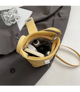 Interior view of yellow bucket bag with zipper pocket and skincare items inside