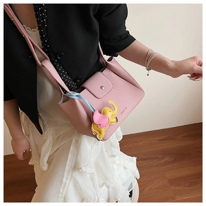 Pink lychee grain leather bucket bag featuring a cute elephant charm and metal closure