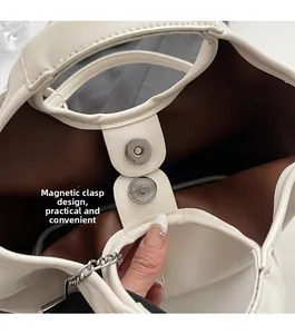 Detailed view of the white PU leather bag with magnetic buckle and brown lining