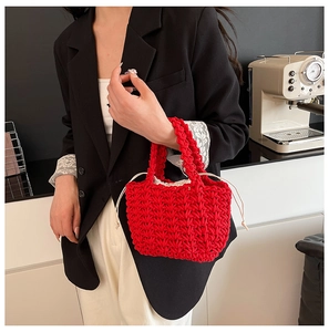 Close-up of a red woven cotton rope handbag with a beige drawstring inner liner pouch