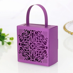 Detail of purple laser-cut lace candy box with floral patterns and integrated handle