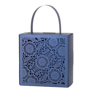 Detail of laser-cut floral patterns on dark blue gift box with handles for weddings