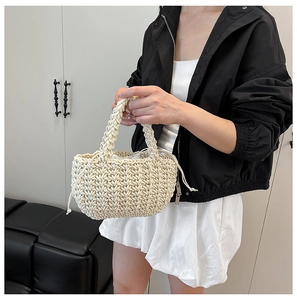 Detailed shot of bohemian beige woven bucket bag with secure canvas drawstring lining