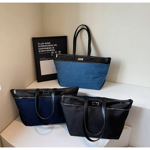 Three denim tote bags in light blue, dark blue and black with leather trim and metal zippers