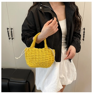 Close-up of vibrant yellow hand-woven bucket bag with white drawstring liner and knit texture