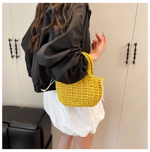 Detail of bright yellow woven bucket bag with thick V-shaped texture and drawstring