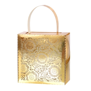 Detailed laser-cut floral pattern on a gold wedding favor box with a stylish handle