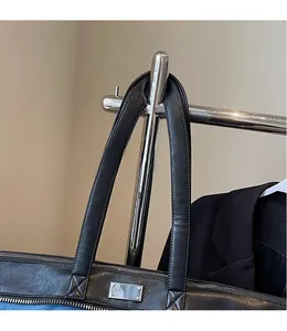 Close-up of durable leather handle and zipper on denim patchwork tote bag