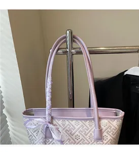 Detailed view of purple geometric pattern tote bag with delicate lace bow decoration