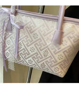 Detail of light purple jacquard bucket bag with lace bow and geometric floral patterns