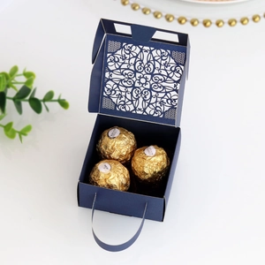 Detailed laser-cut hollow pattern on dark blue square wedding gift box with ribbon