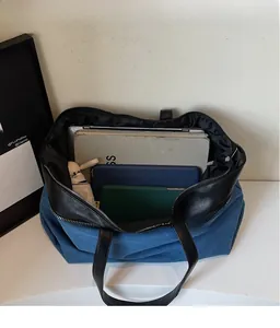 Top view of blue denim tote bag interior showing large capacity for laptop and tablet