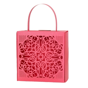 Intricate laser-cut floral pattern detail on pink wedding favor gift box with handle