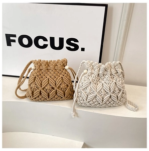 Close-up of handmade macrame drawstring bucket bags in khaki and beige cotton rope