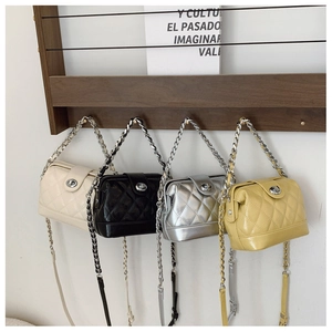 Detailed macro view of quilted texture and metal twist locks on four colorful chain bags
