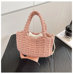 Detail of pink hand-woven crochet bucket bag with secure inner drawstring pouch