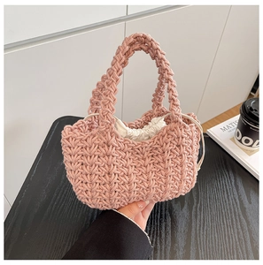 Detail of pink woven bucket bag with cotton rope texture and white drawstring inner pouch