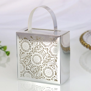 Silver laser-cut candy box with elegant hollow floral patterns and portable handle design