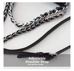 Detail of adjustable black leather strap with silver metal chain on crossbody bag