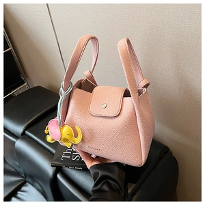 Pink lychee grain leather bucket bag with top handles and cute elephant charm