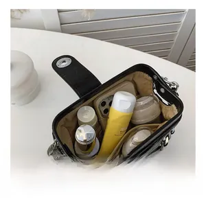 Detailed view of the black quilted crossbody bag's large interior capacity and storage space