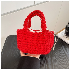 Detail of red hand-woven bucket bag featuring a cream-colored drawstring lining